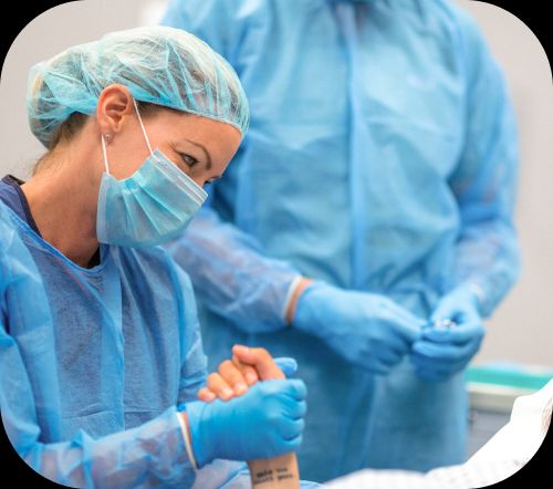 Surgeon holding hand of patient before a procedure.