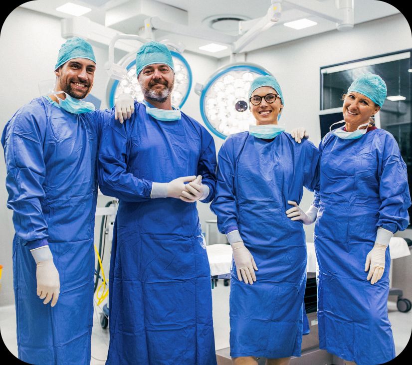 Four surgeons celebrating after a successful procedure.